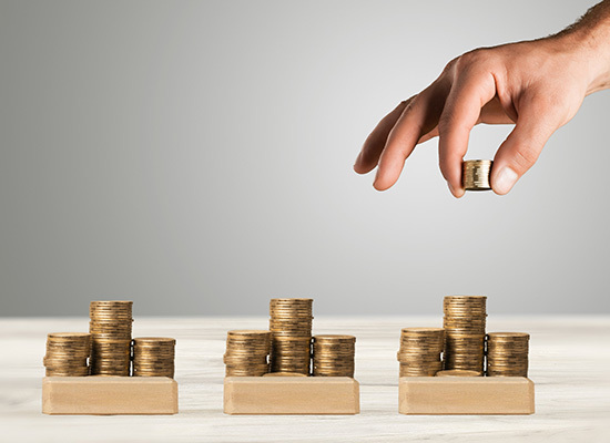 coins being stacked on different wooden blocks