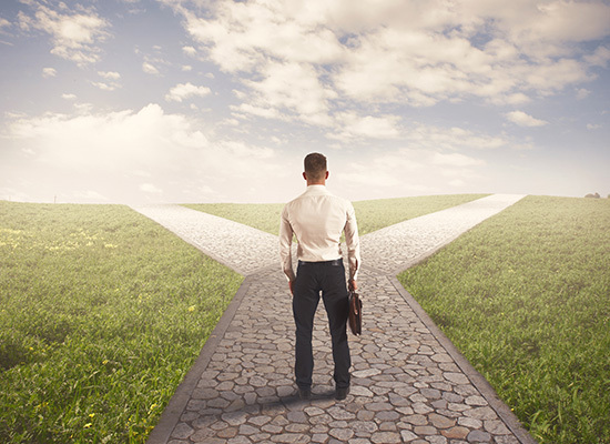 a man standing at a crossroads with briefcase