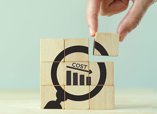 wooden blocks with the image of cost going down