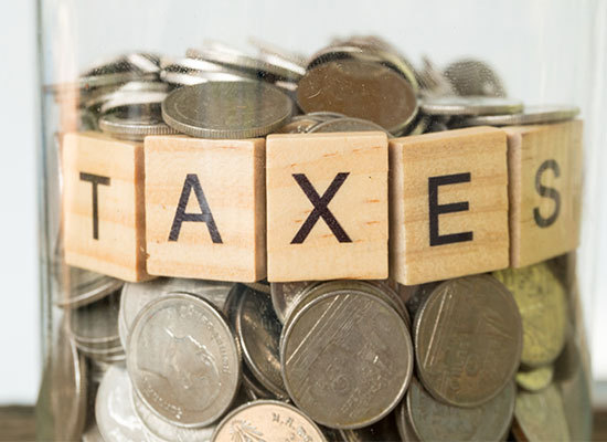 jar of money labeled taxes
