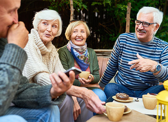 older couples outside having coffee