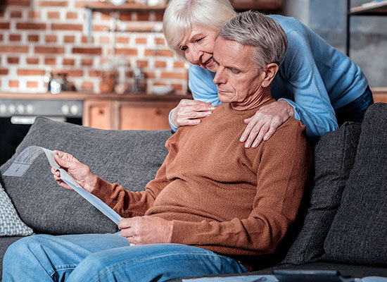 elderly husband and wife viewing social securty document