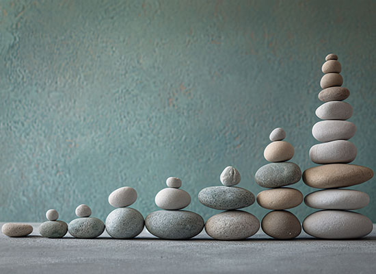 round pebbles stacked in a graph formation showing growth