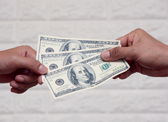 money being passed from one hand to another