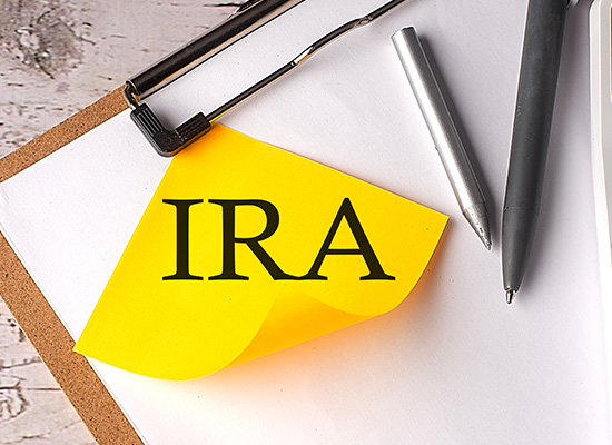 a stickey note labeled IRA on a clipboard