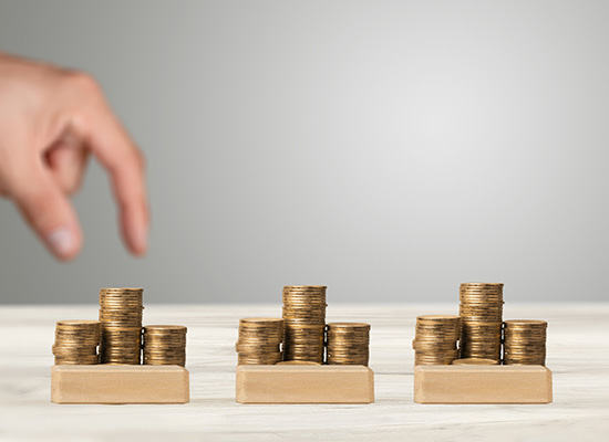 Stacks of coins representing different retirement income strategies in a financial planning context.
