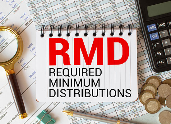 A notebook with 'RMD Required Minimum Distributions' written on it, surrounded by financial documents, coins, and a calculator, emphasizing retirement income planning and tax-efficient withdrawals.