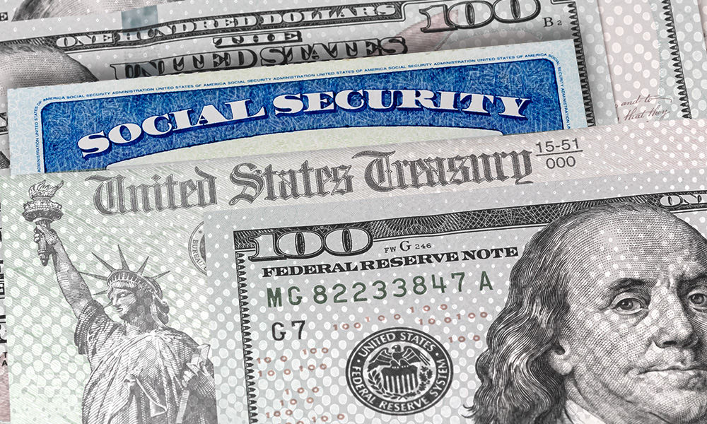 A Social Security card partially hidden among U.S. Treasury and one hundred dollar bills, representing financial support and benefits for retirees.