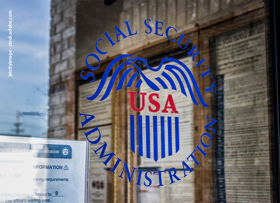 A glass door with the Social Security Administration logo featuring a stylized eagle and the letters 'USA' in red, and 'Social Security Administration' in blue