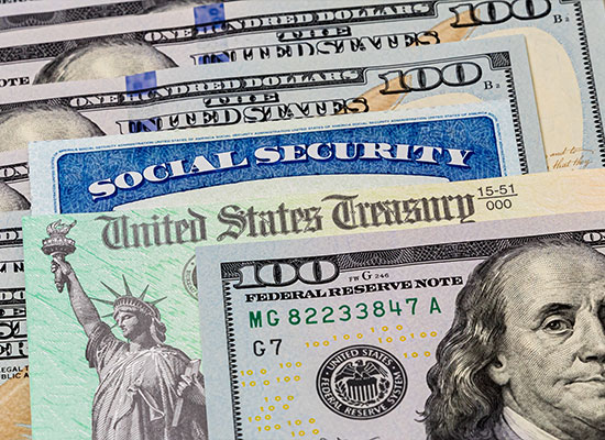 Close-up of various U.S. financial documents, including hundred-dollar bills, a Social Security card, and a United States Treasury check.
