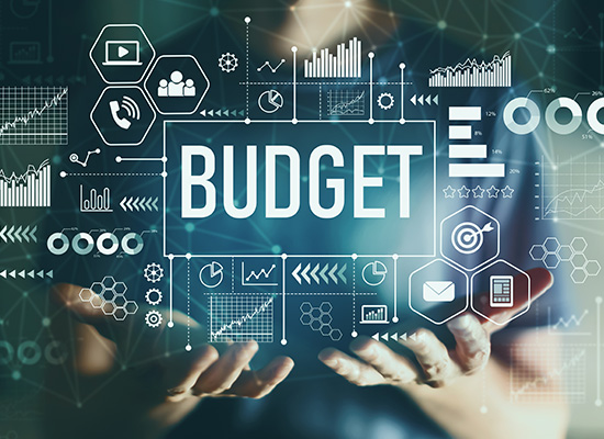 A digital display showcasing various financial charts, graphs, and icons surrounding the word 'BUDGET' in the center, representing budgetary planning and analysis.