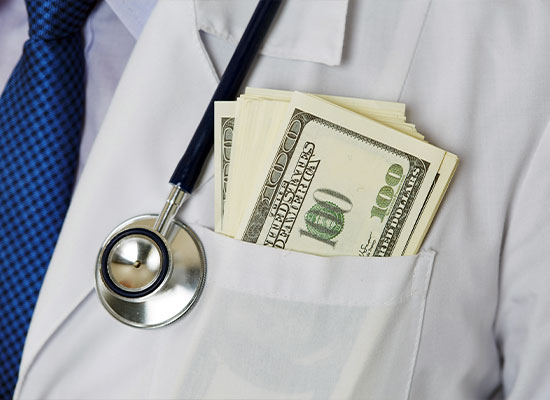 A person in a white coat with a stethoscope draped around their neck has a pocket filled with bundles of 100-dollar bills. 