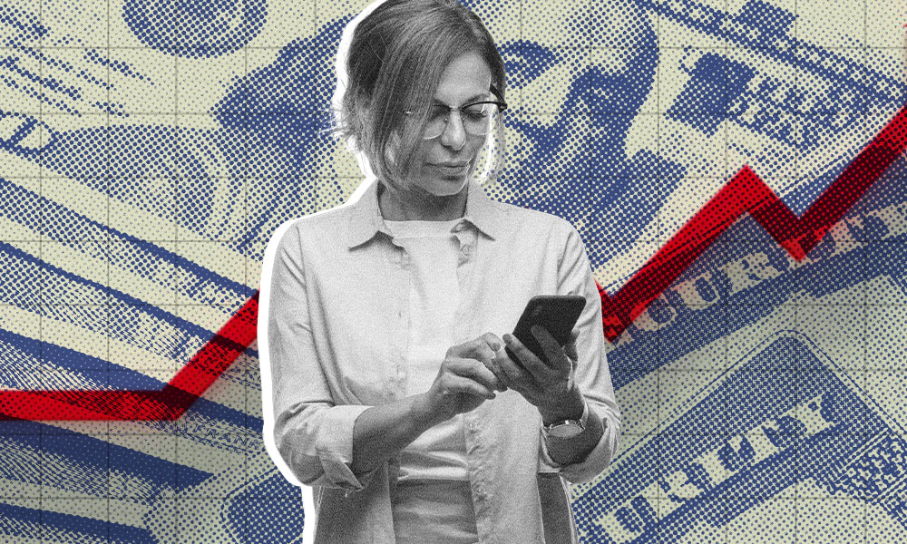 A woman in glasses and a light blouse uses her smartphone. In the background, large images of currency notes and a red upward-trending graph hint at inflation trends or cost-of-living adjustments
