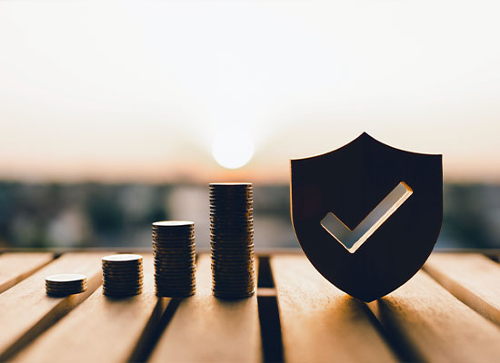 Stacks of coins are arranged in ascending order on a wooden surface, symbolizing careful estate planning.