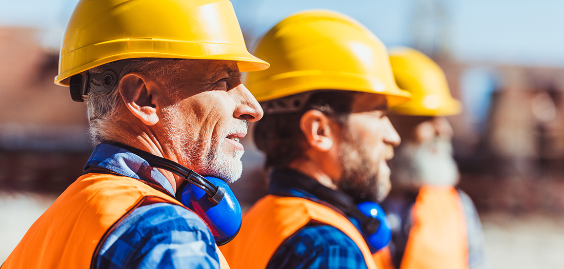 Row of elderly men working in construction