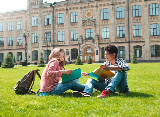 two college students studying in the court yard of their university due to a 529 college savings plan