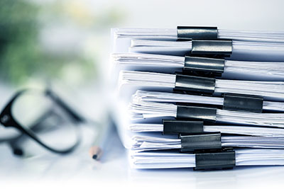 Stack of legal documents in binder clips