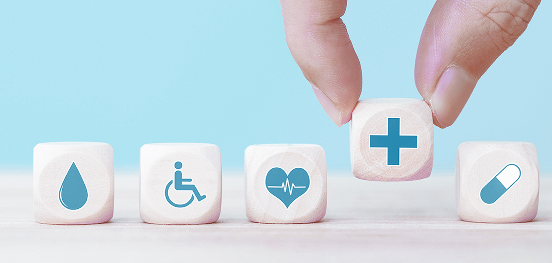 Five white dice showing icon pictures of water, health and disabilities