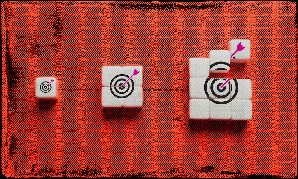 White blocks with increasingly larger bullseye targets and arrows arranged in a progression on a red background, symbolizing key age milestones and growing financial goals along the retirement journey.