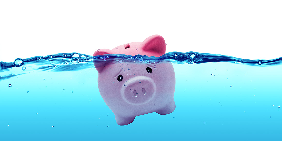 Sad piggy bank sinking underwater