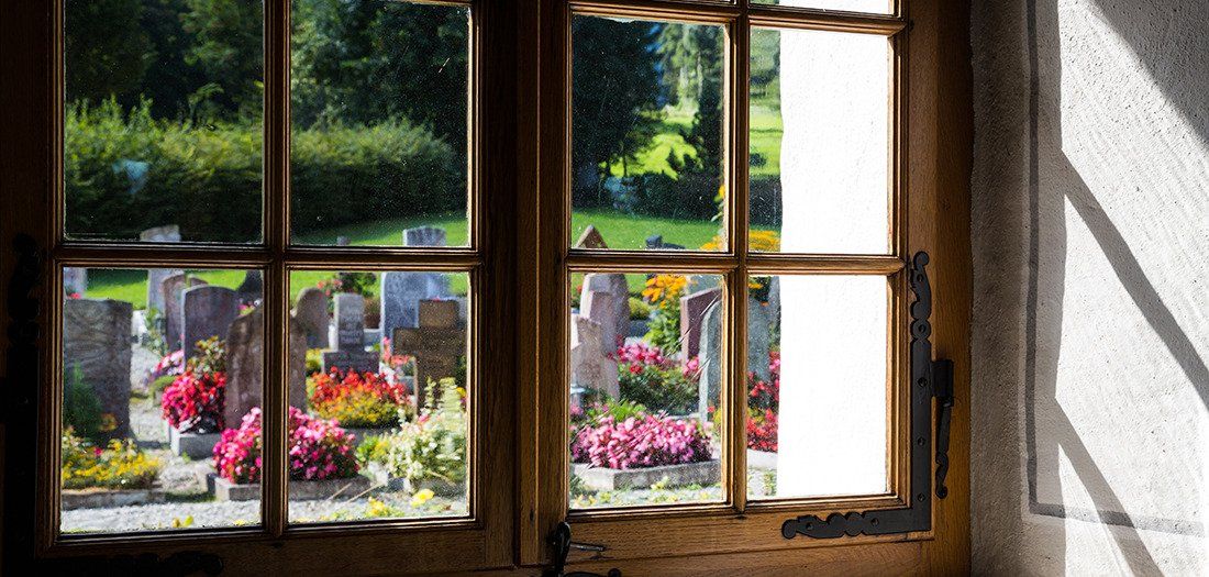 Church window looking out over cemetery