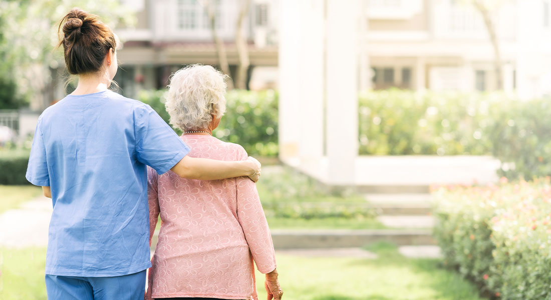a caregiver with their arm around a senior 
