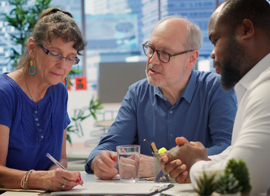 A group of individuals at retirement age discussing financial planning, estate planning, and prenuptial agreements for a late-life marriage