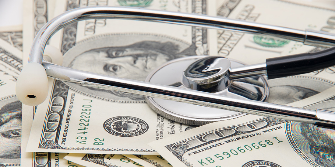 Stethoscope sitting on cash