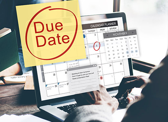 person at laptop looking at calendar with due dates