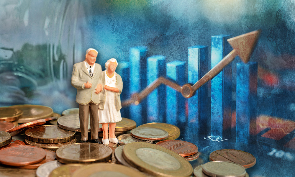A figurine of an elderly couple standing on a pile of coins with a rising bar graph in the background, symbolizing improving retirement confidence in America.