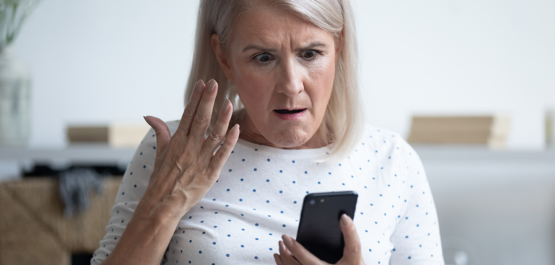 Older woman shocked by a cell phone call