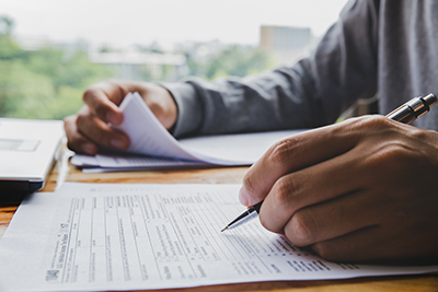 Man filling out legal documents