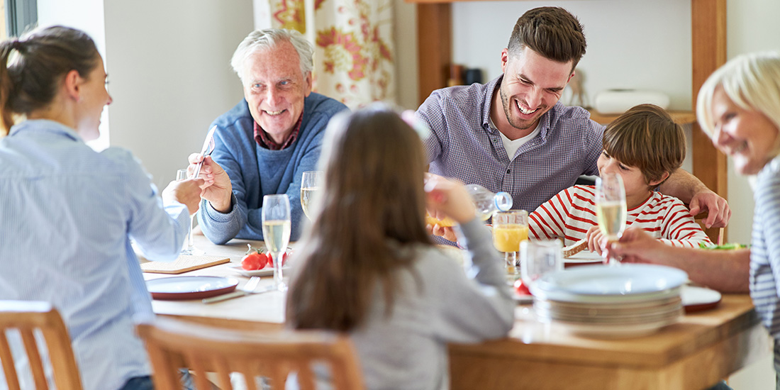Happy multigenerational family living together, having breakfast