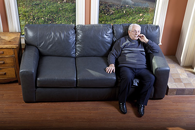 Lonely old man sits alone in his house