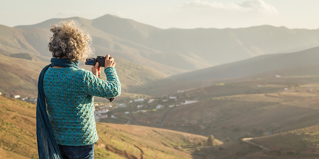 Senior woman taking a picture on vacation