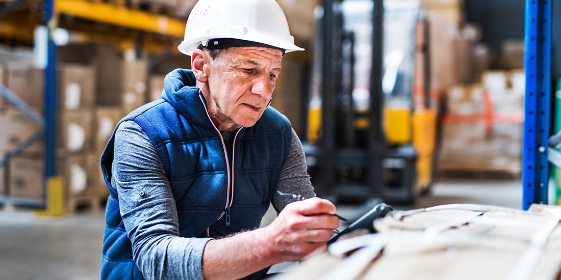 Senior man in a hard hat at the worksite