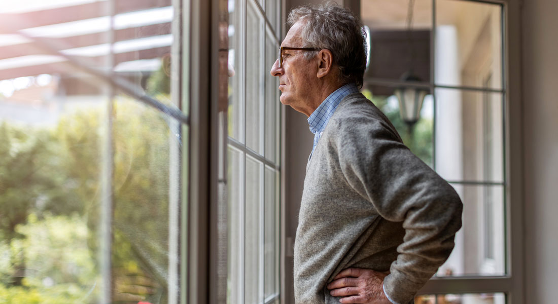 Older man looking out the window