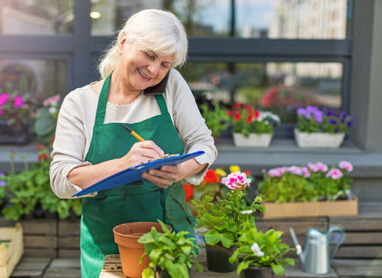 An older woman working with a smile on her face