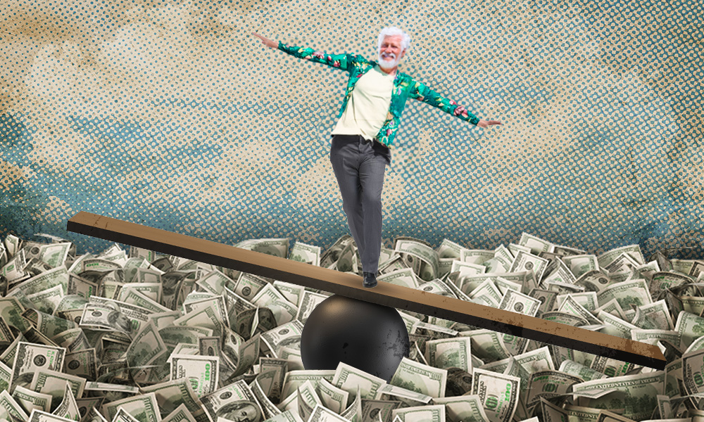 man balancing on a board above a pile of cash