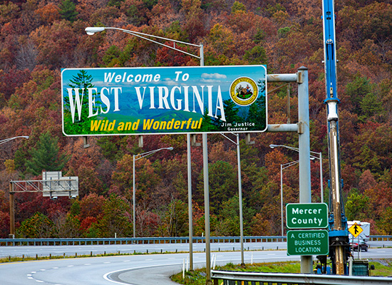 A sign indicating West Virginia, symbolizing a potential relocation destination for retirees seeking affordable living options.