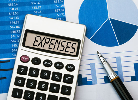 Financial charts and a calculator displaying 'Expenses' symbolize the financial challenges of retirement for American seniors and the potential impact of age discrimination on their careers and employment.