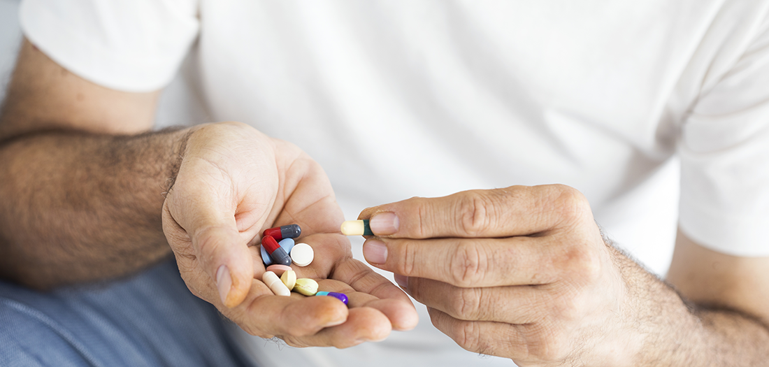 A man with a handful of medications
