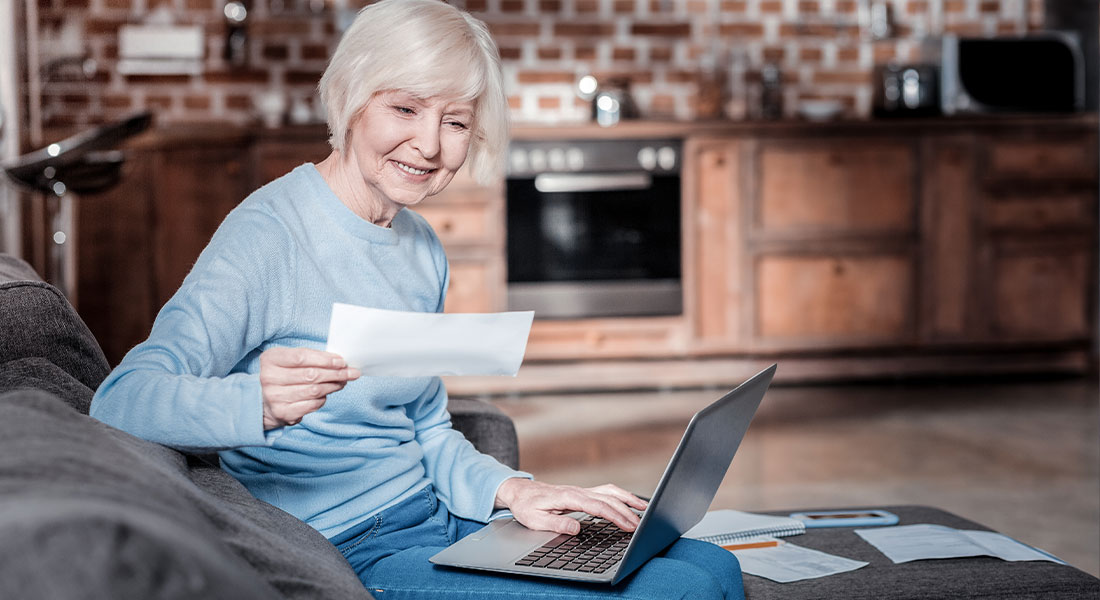 A woman smiling at her social security check.