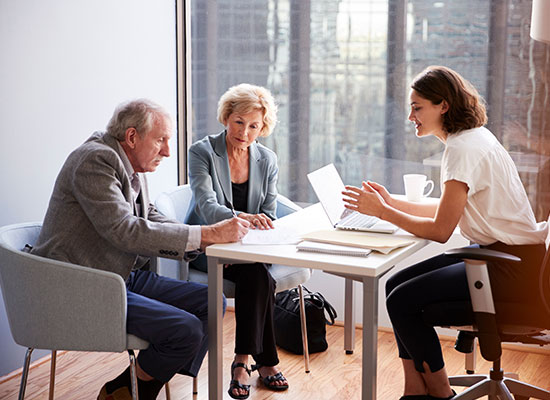 senior couple going over living arrangements with someone